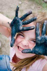 Little girl happy with finger paints